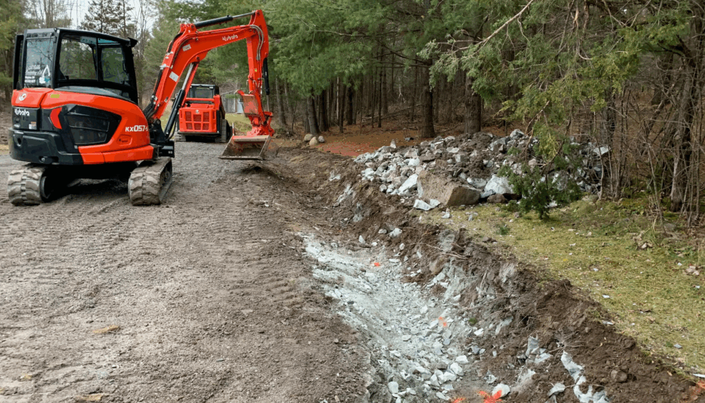 M. Riddle Excavating digging ditches and culverts to divert water from the driveway.