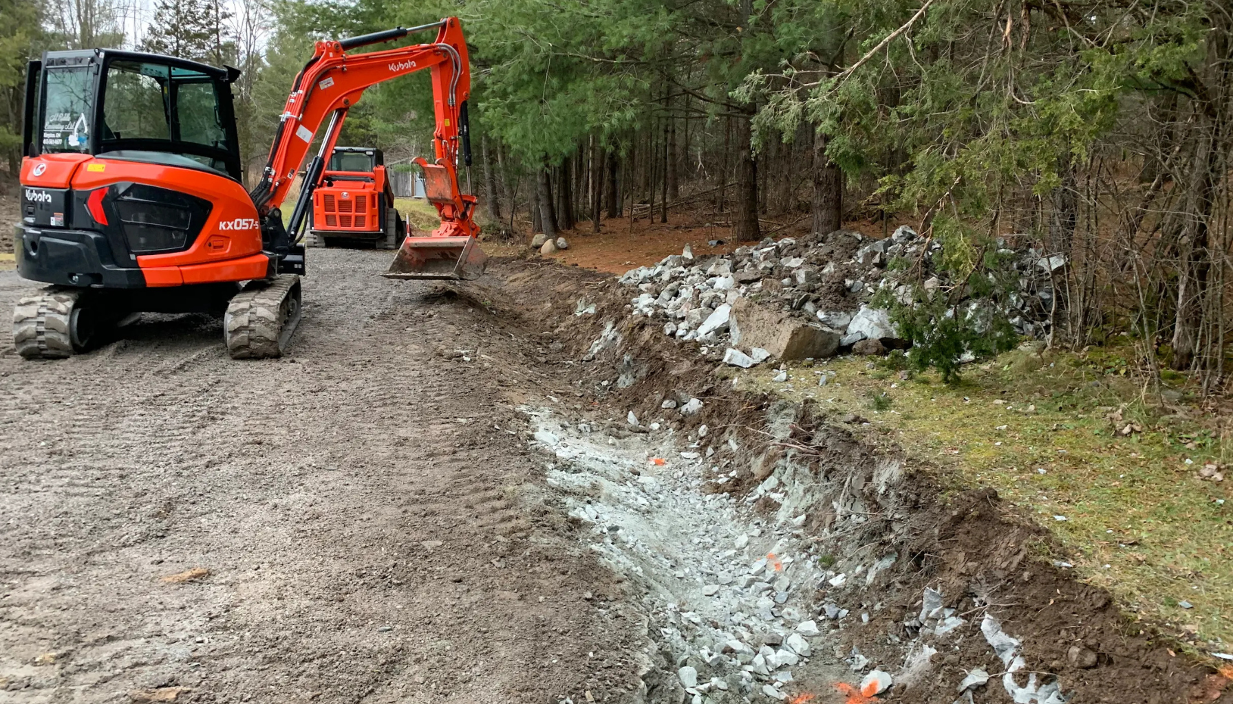 M. Riddle Excavating digging ditches and culverts to divert water from the driveway.