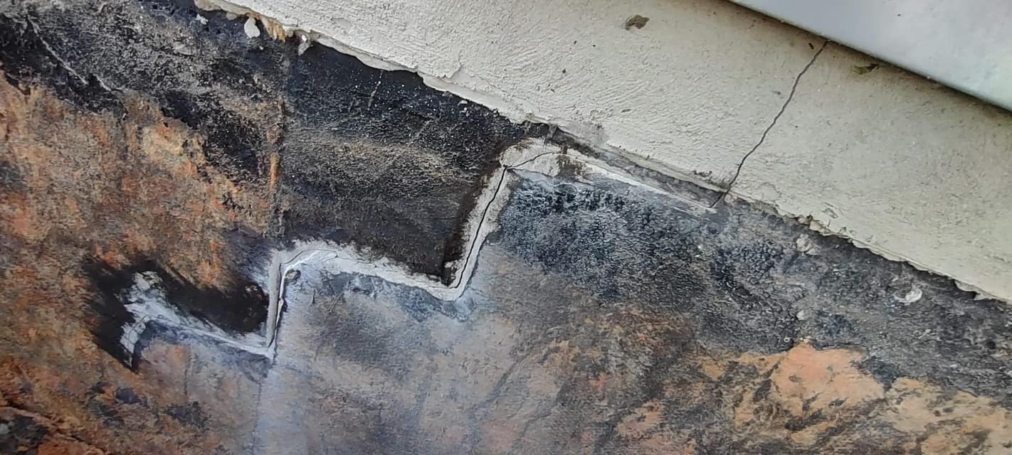 A cracked cement foundation of a home.