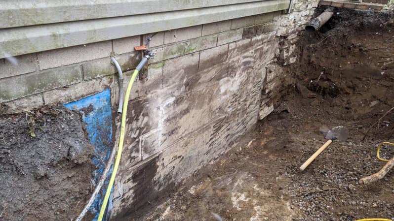 Foundation repair with visible water membrane