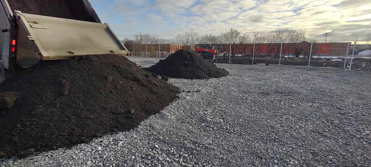 A truck dumping soil.