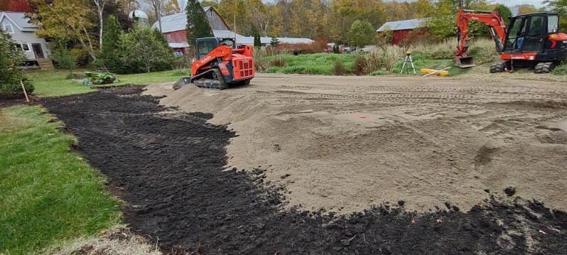 Grading soil on a large lot.