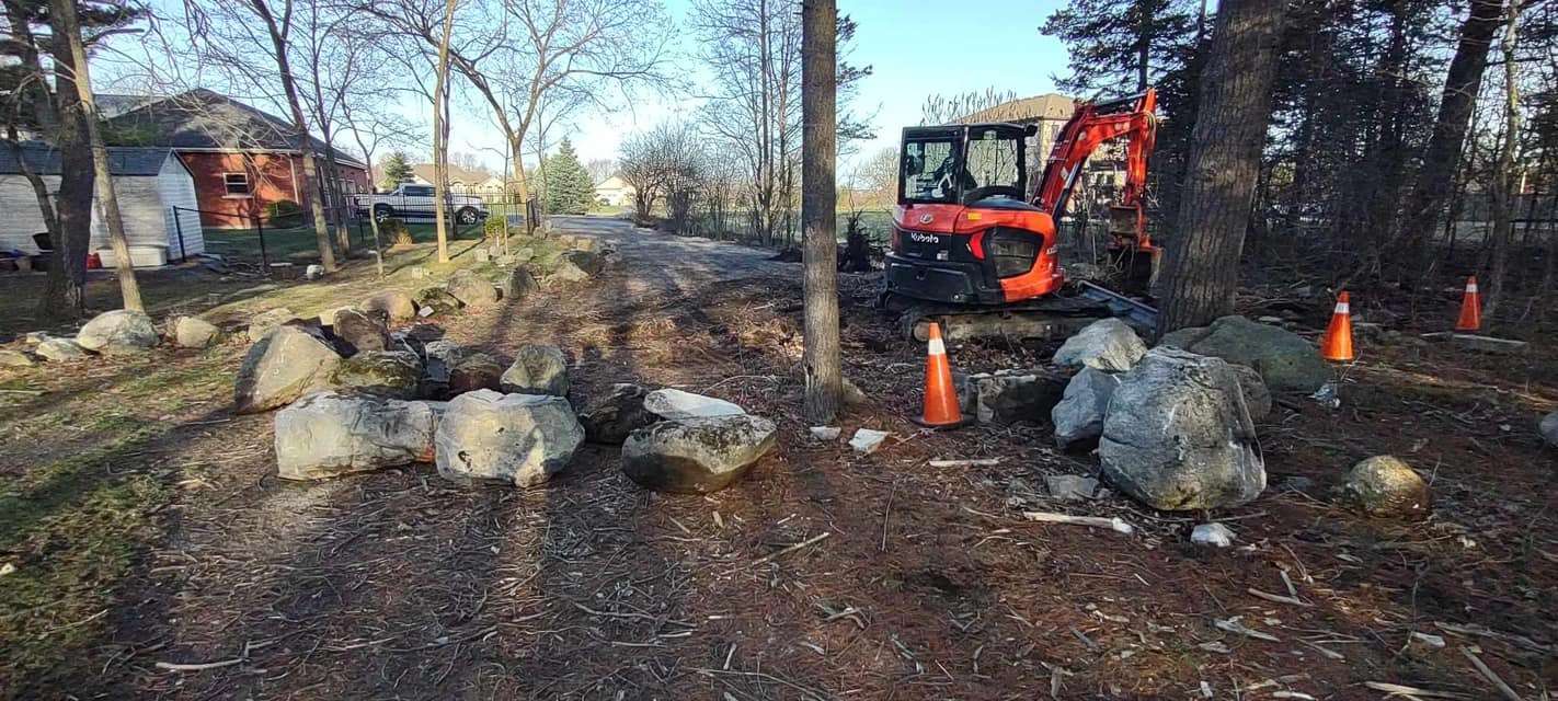 Excavation and landscaping on a residential property.